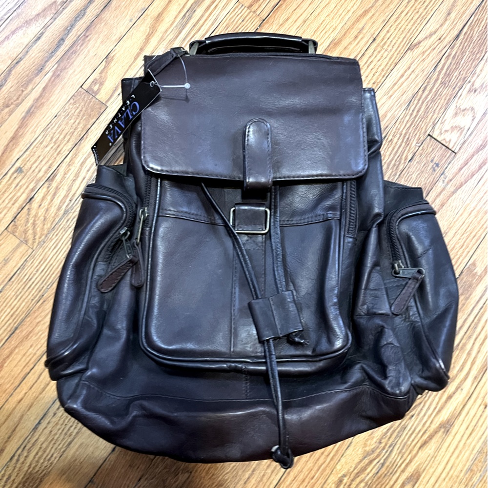 Clava Leather dark brown backpack. Never used. EUC. Tag still on. Unique style.